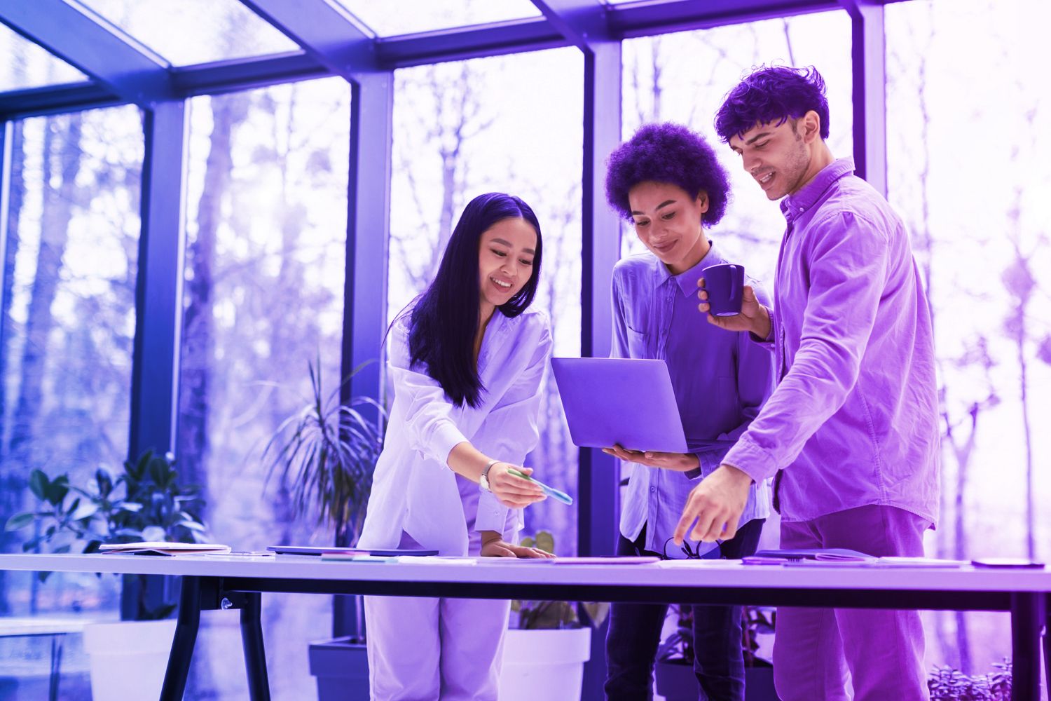 three people looking at laptop