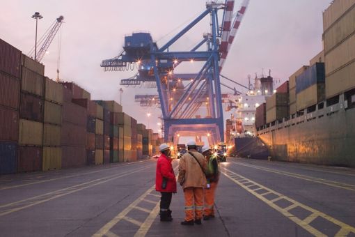Cargo shipping port with workers