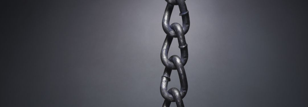 chain with gold link on black wall