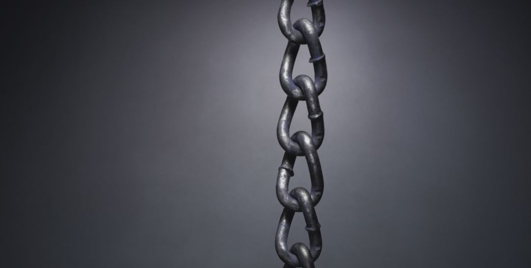 chain with gold link on black wall