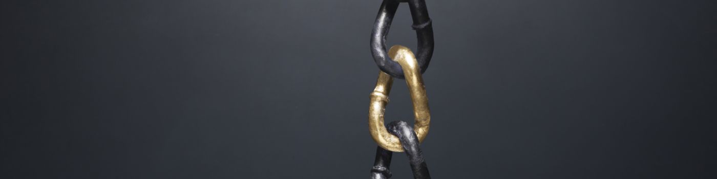 chain with gold link on black wall