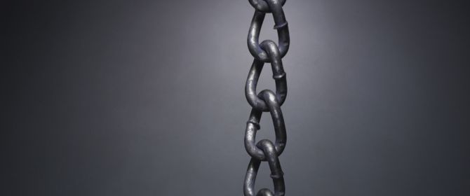 chain with gold link on black wall