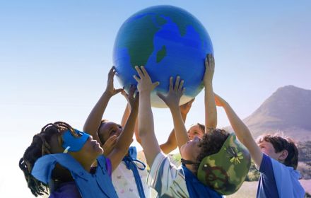Children holding world globe in the air