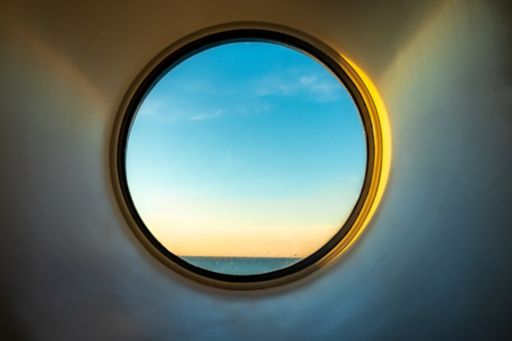 Circular window with sky and ocean