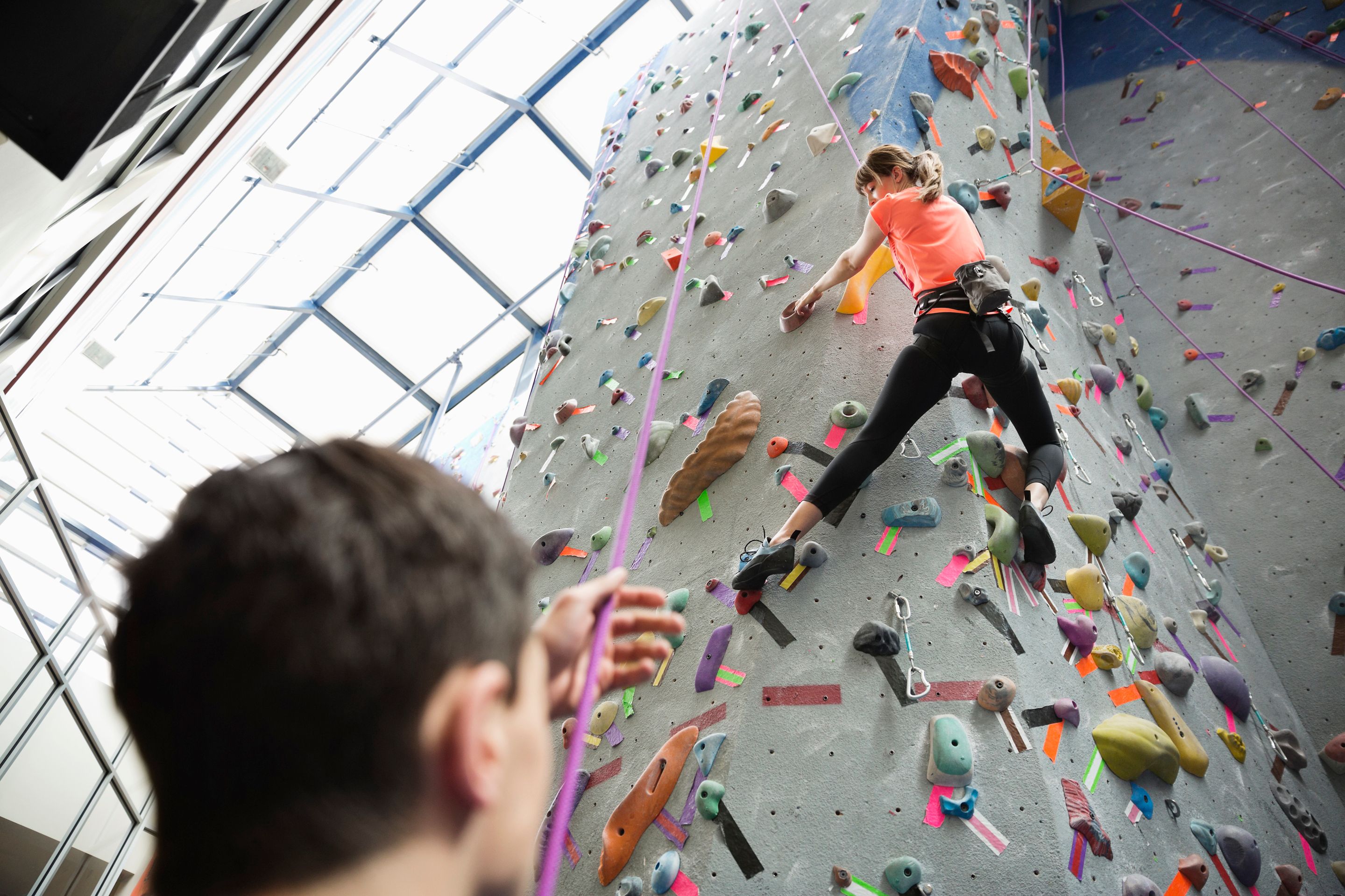 Woman climbing wall