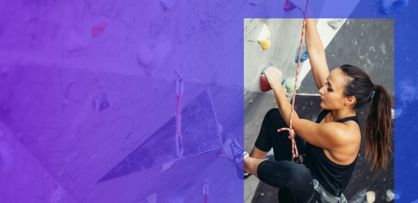 climbing woman in indoor hall holding grip