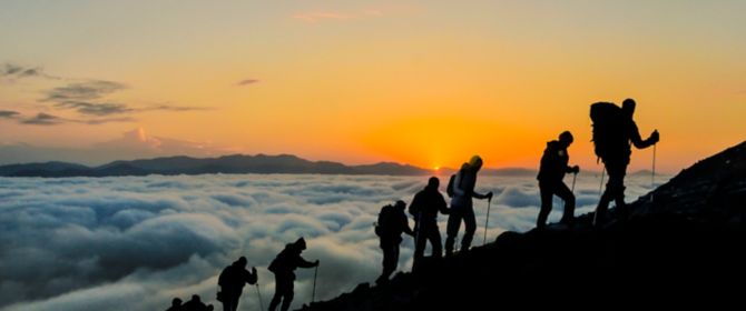 Climbers group on mountain during sunset