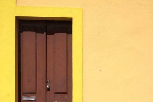 Brown door in yellow building