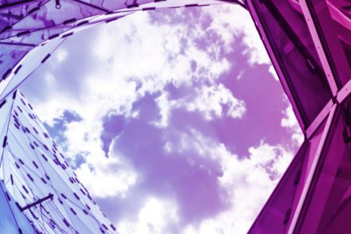 clouds-between-blue-and-pink-glass-buildings-banner