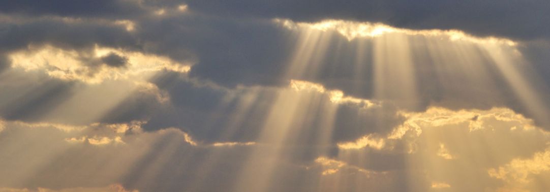 KPMG IFRS Financial Instruments topic image: clouds and shafts of sunlight over water