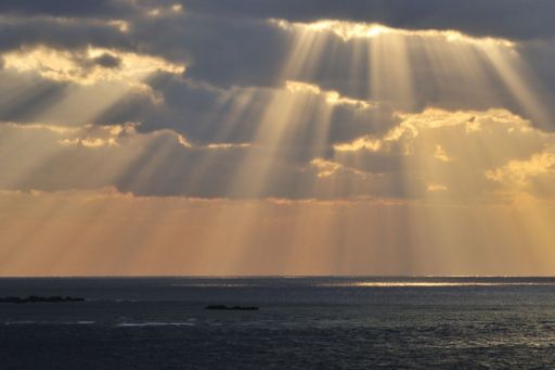 KPMG IFRS Financial Instruments topic image: clouds and shafts of sunlight over water