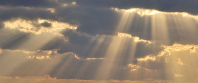 KPMG IFRS Financial Instruments topic image: shafts of sunlight through clouds over the sea