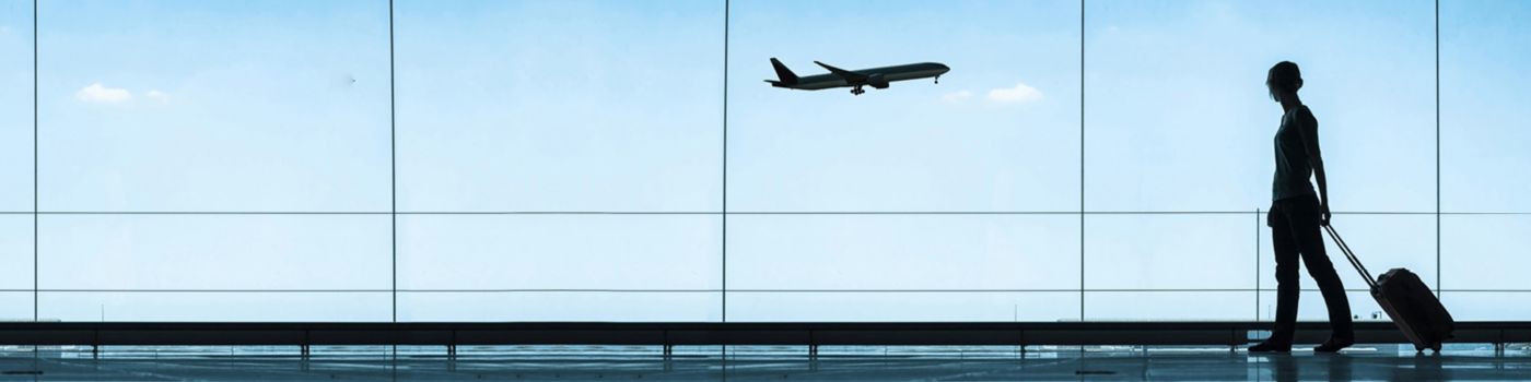 Silhoutte lady with luggage at airport
