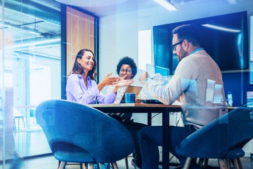 Coworkers sitting in bright office meeting room