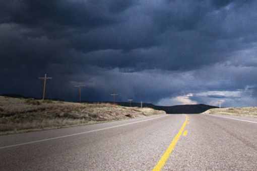 dark clouds above empty road banner