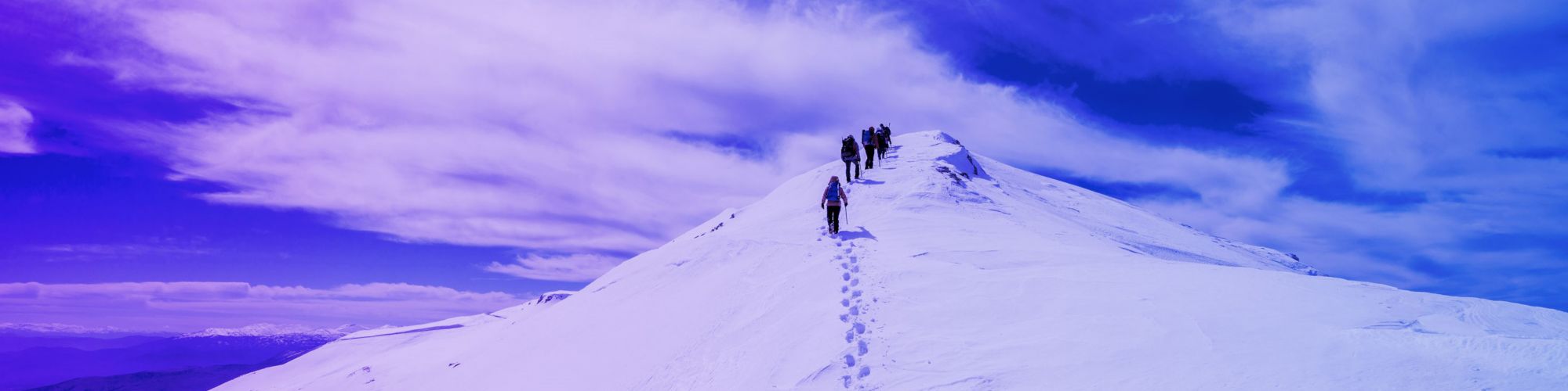 People hiking on mountain with snow