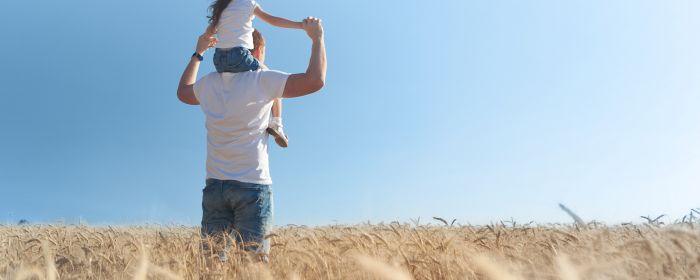 Child sitting on shoulders of parent