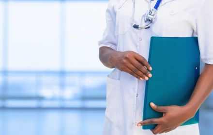 Doctor holding blue green file wearing stethoscope white coat