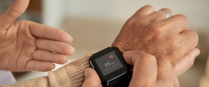 elderly person monitoring heartbeat on smartwatch