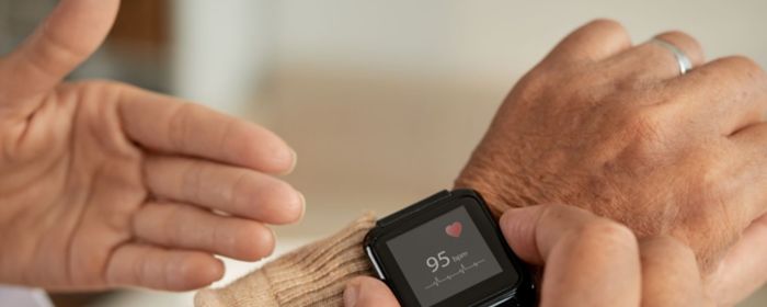 elderly person monitoring heartbeat on smartwatch