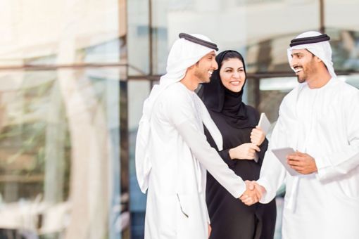 Emirati colleagues shaking hands