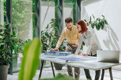 man and woman are working with solar panels