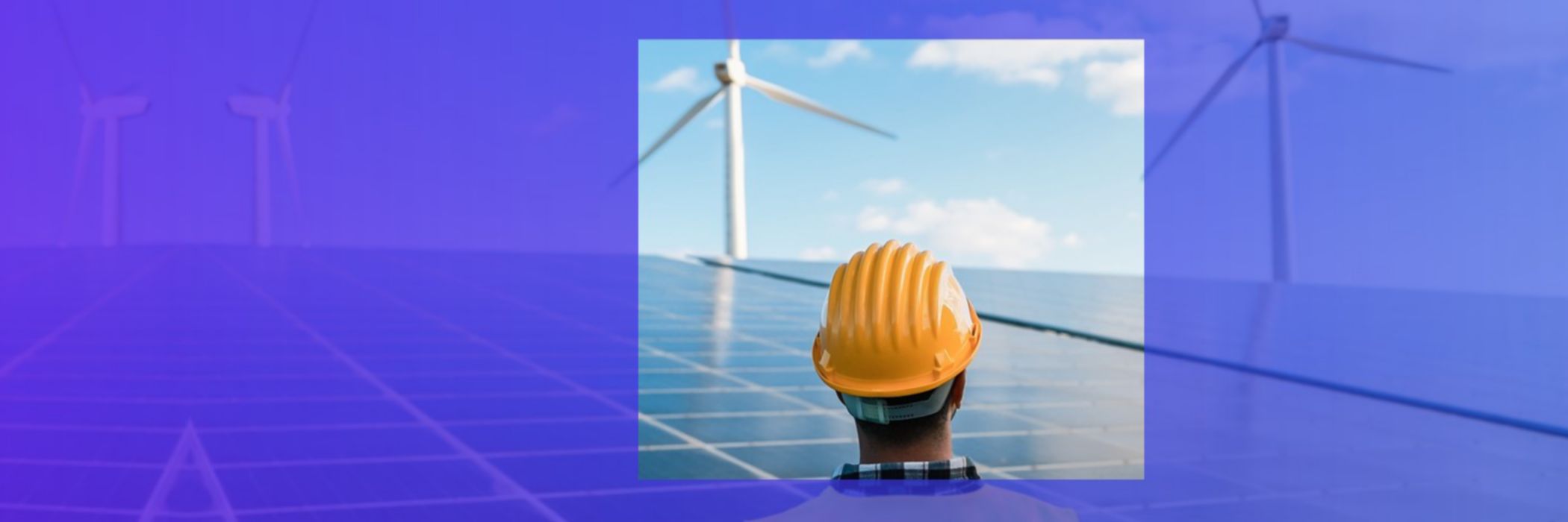 engineer looking at solar panels and wind turbines