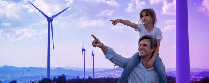 father and kid pointing at windmills