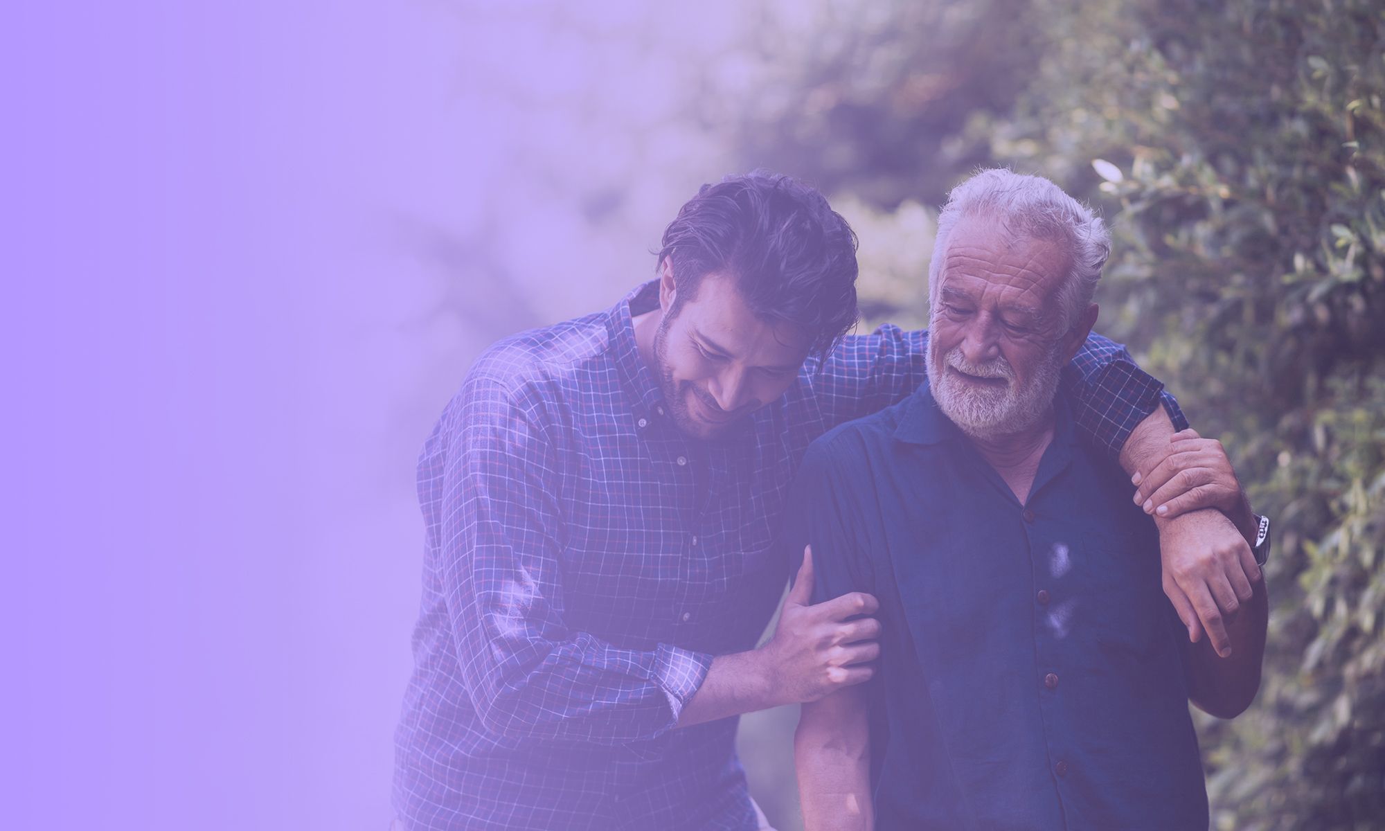 A smiling elderly father and his son go for a walk