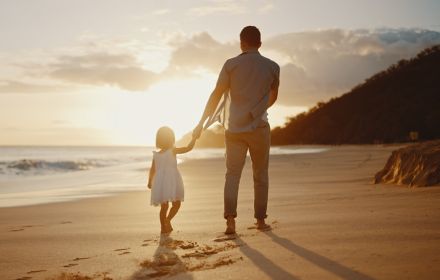 Father daughter walking on a beach