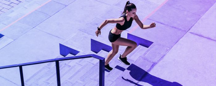 Female runner going up a set of stairs