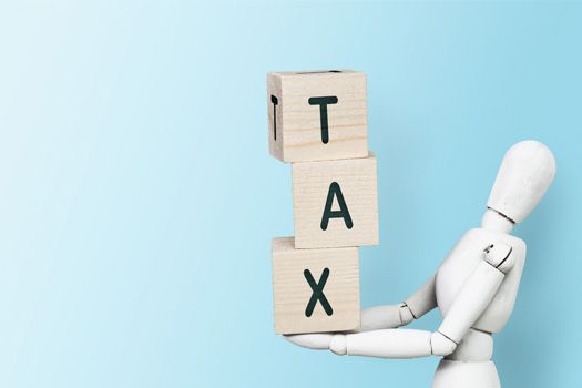 figure holding tax blocks