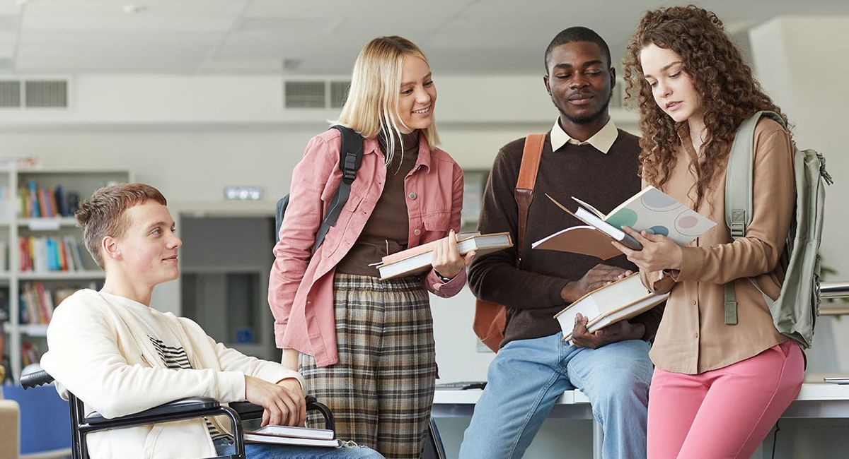 Four students looking at books together