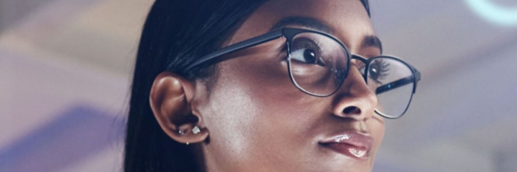 Frau mit Brille liest Codezeilen