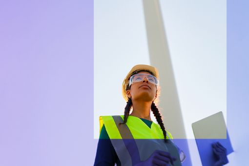 Woman with helmet at the wind turbine