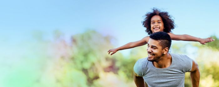 Father giving his daughter a piggyback