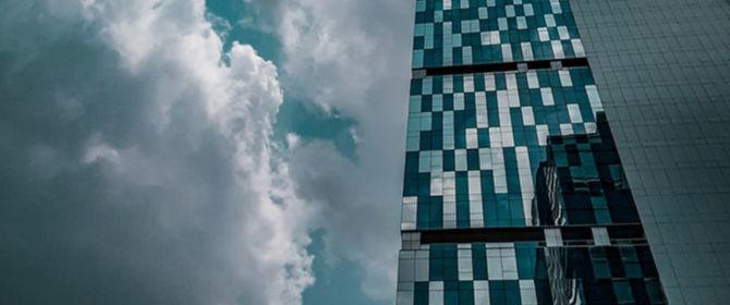 Glass building with clouds