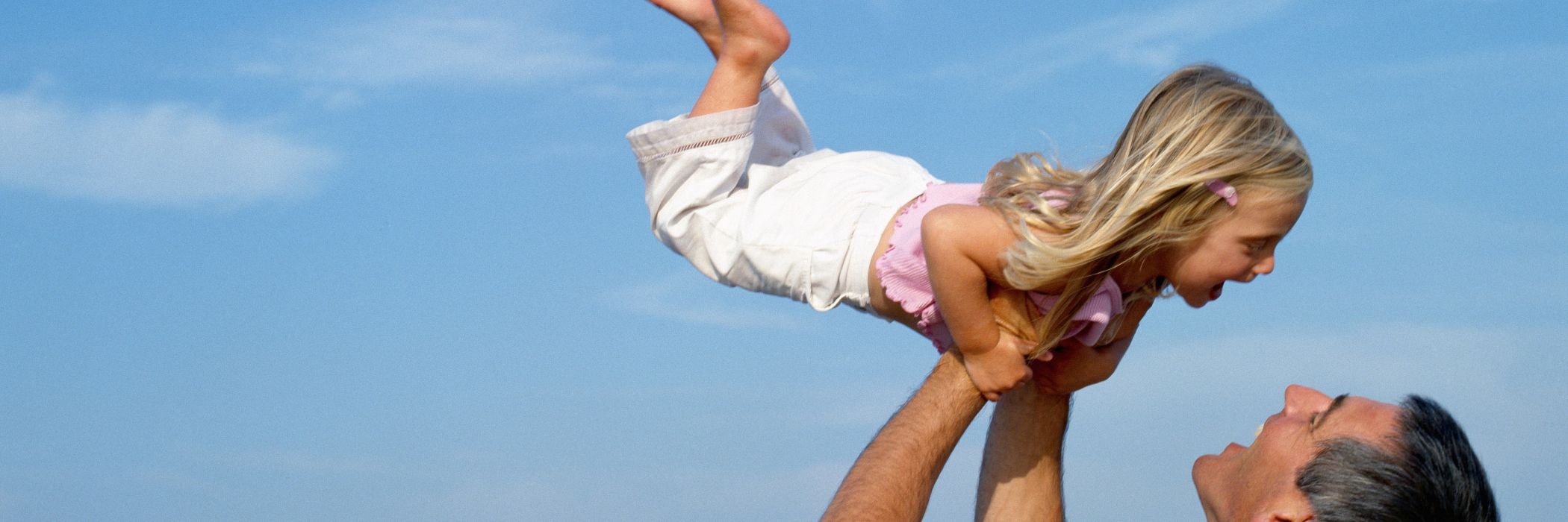 Father lifting girl
