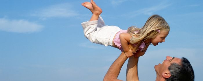 Father lifting girl