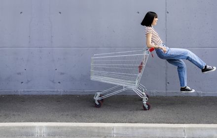 Girl playing with shopping cart