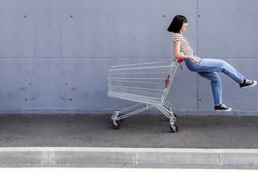 Girl playing with shopping cart