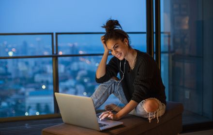 Girl sitting using her laptop