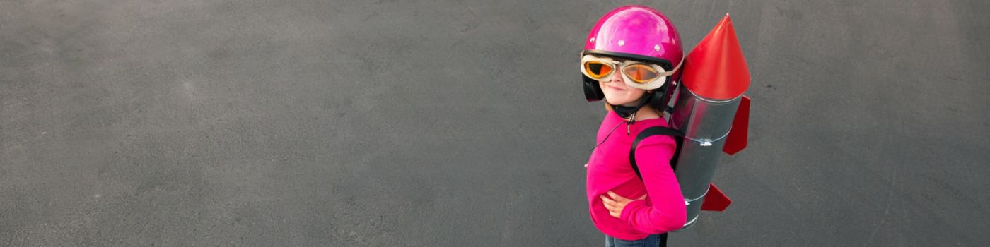 Girl wearing pink helmet dummy rocket bag-pack standing on road