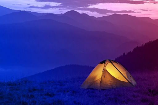 Glowing tent in mountains