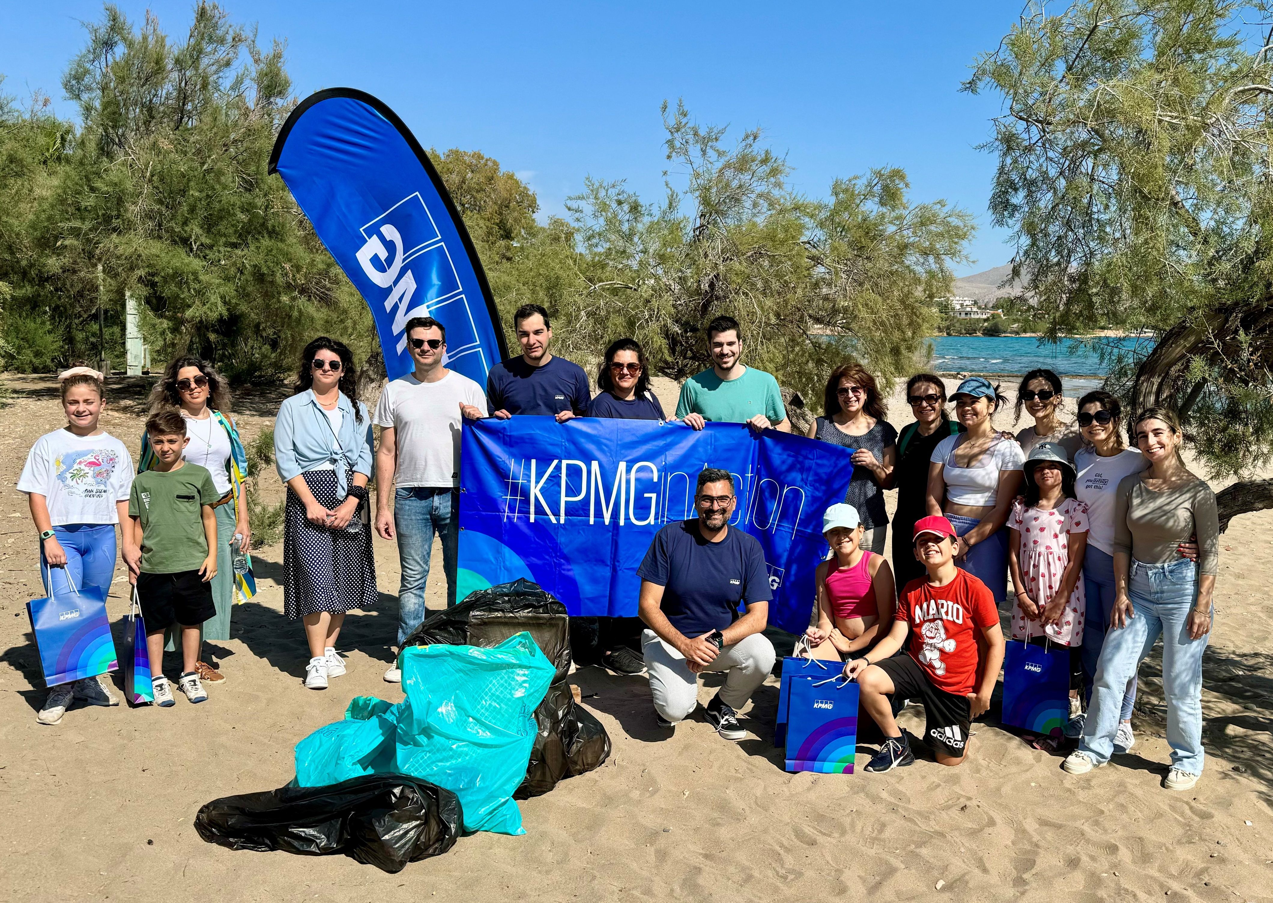 group photo of kpmg employees after beach cleaning csr activity