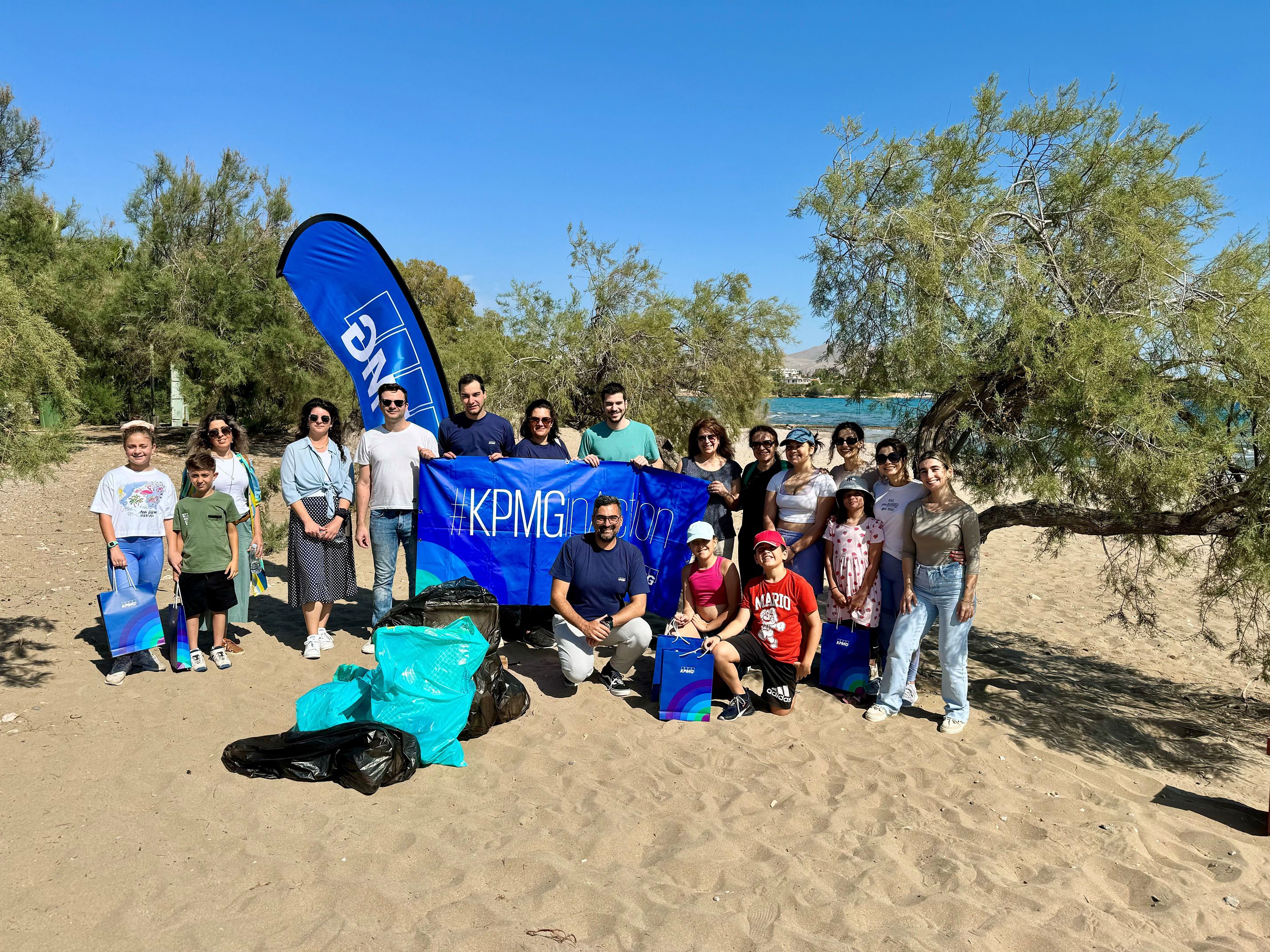 group photo of employee from kpmg greece after beach cleanup in agios dimitrios saronic gulf