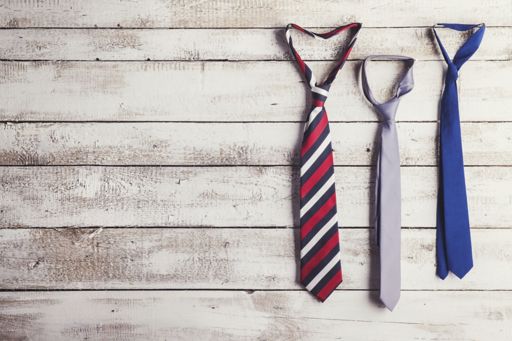 Ties hanging from wooden wall