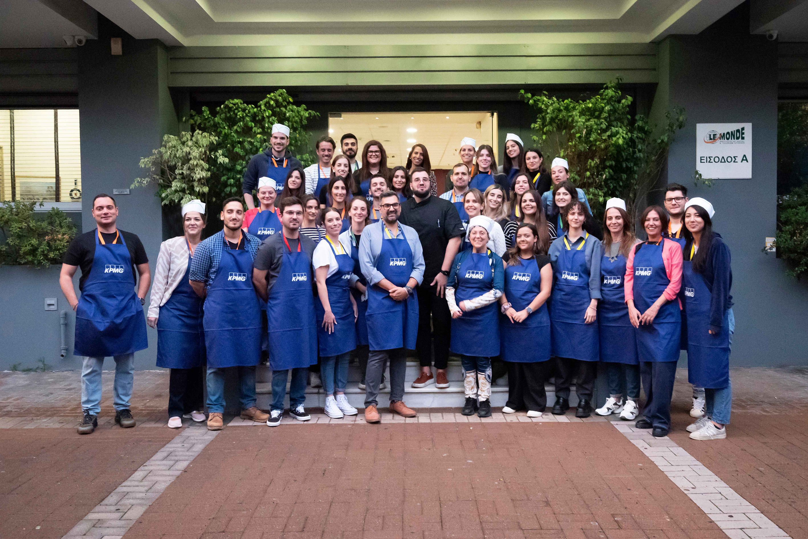 kpmg greece employees participating in cook for good 2023 with stavros varthalitis
