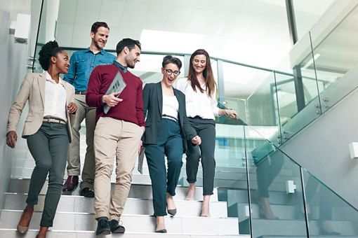 Group of business people walking down stairs