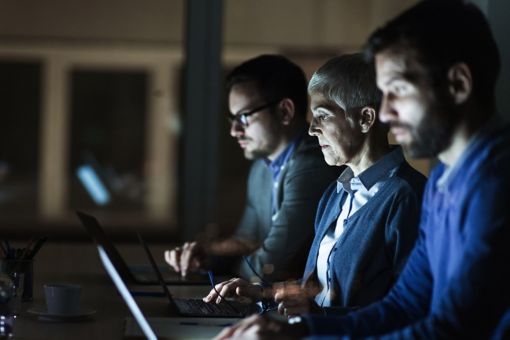 Businesspeople looking at computer screens